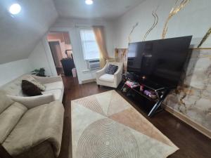 a living room with a large flat screen tv at Humble beginning 605 EM in Norwich