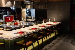 a kitchen with a long counter with wine glasses on it at THE BLESS Awaji in Sumoto +27 photos