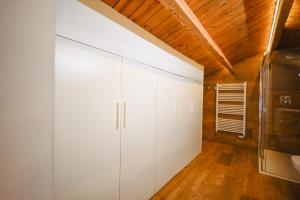 a bathroom with white cabinets and a wooden ceiling at Xalet Les Avellanes - hut 7335 in Arinsal +38 photos