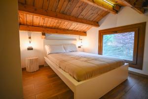 a bed in a room with a large window at Xalet Les Avellanes - hut 7335 in Arinsal