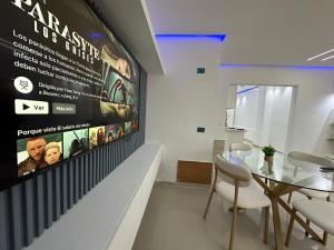 a dining room with a large poster on the wall at Ts02 torre B in La Romana