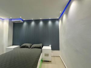 a bedroom with a bed with a black and white wall at Ts02 torre B in La Romana