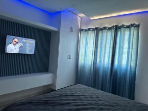 a bedroom with a tv on the wall and a bed at Ts02 torre B in La Romana