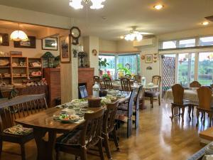 a dining room with tables and chairs in a restaurant at Natsumi no Sato in Biei