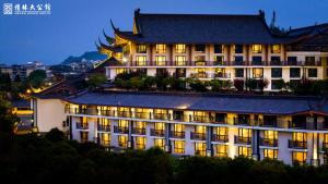 a hotel with lights on in front of a building at Grand Bravo Guilin in Guilin