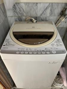 a white toilet in a small room with at 空港近くの温泉宿 翻車魚庵 in Kirishima