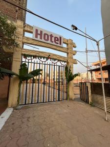 a gate to a hotel with a sign on it at Hotel GMP in Hoshangābād
