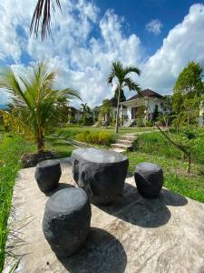a group of rocks sitting on top of a sidewalk at Umaku Bali Homestay in Munduk