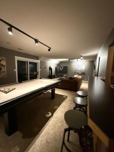 a living room with a pool table and a couch at Tall Trees Departure Bay Nanaimo in Nanaimo