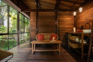 a room with a bench in a room with wooden walls at Casa Selva Sayulita in Sayulita +67 photos