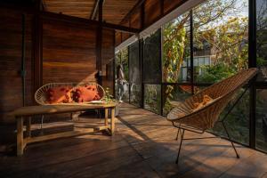 a room with a table and chairs on a porch at Casa Selva Sayulita in Sayulita