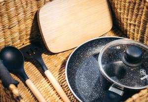 a frying pan on a table with a wooden spoon at Casa Selva Sayulita in Sayulita