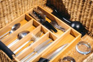 a wooden drawer with utensils in a wooden box at Casa Selva Sayulita in Sayulita