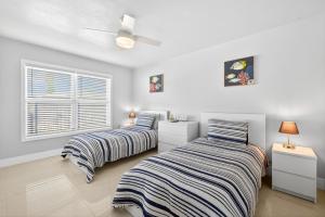a bedroom with two beds and a window at Downtown Breeze in Cape Coral +82 photos