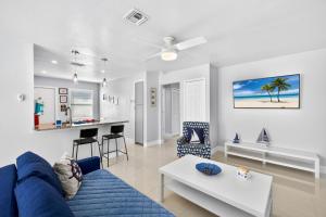 a living room with a blue couch and a table at Downtown Breeze in Cape Coral