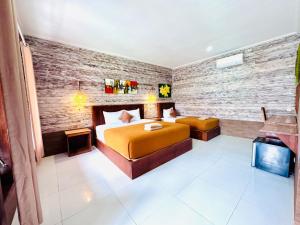 a hotel room with a bed and a couch at Dtegal Private Villa in Klungkung