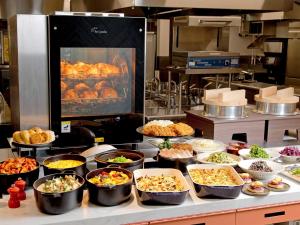 a buffet line with many different types of food at Hotel Elcient Kyoto Hachijoguchi in Kyoto
