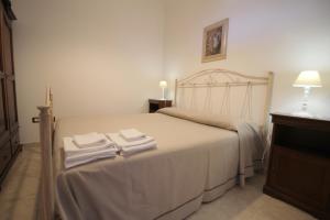a bedroom with a bed with two towels on it at Home Holiday Salento Monica's House in Otranto +18 photos