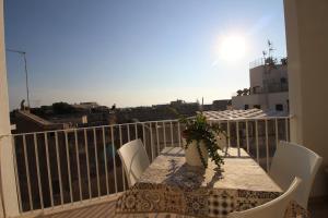 a table and chairs on a balcony with a view at Home Holiday Salento Monica's House in Otranto