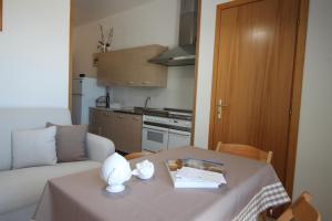 a living room with a table and a couch at Home Holiday Salento Monica's House in Otranto