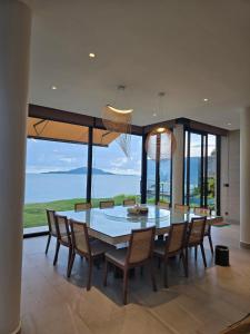 a dining room with a large table and chairs at Sabi by the Sea Kep in Kep