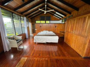 a bedroom with a bed and a ceiling fan at Ucuilagi Resort in Matei