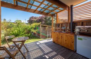 an outdoor kitchen with a table and a stove at Studio at Pohara in Pohara