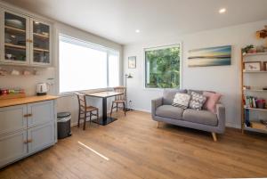 a living room with a couch and a table at Studio at Pohara in Pohara