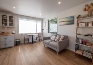a living room with a couch and a table at Studio at Pohara in Pohara