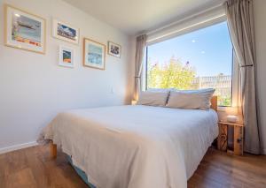 a bedroom with a bed and a large window at Studio at Pohara in Pohara