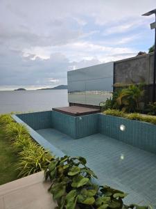 a swimming pool with a view of the water at Sabi by the Sea Kep in Kep +7 photos