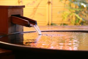 a water fountain in a pool of water at Hotel Tamanoyu in Matsumoto +166 photos
