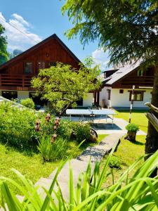 a house with a picnic table in the yard at Casa Rogin Chalet in Buhalniţa