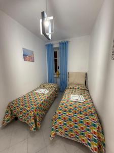 a bedroom with two beds in a room at Alloggio Turistico Marin Valley in Fondi