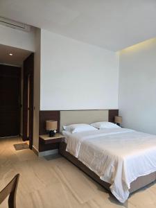 a bedroom with a large bed in a room at Sabi by the Sea Kep in Kep