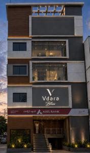 a tall building with a voodoo glass sign on it at Hotel Vdara Bliss in Vijayawāda