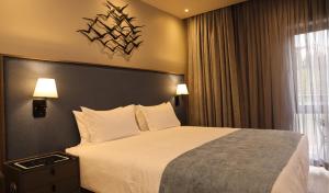a hotel room with a bed and a window at Big Blue Sodwana Bay in Sodwana Bay