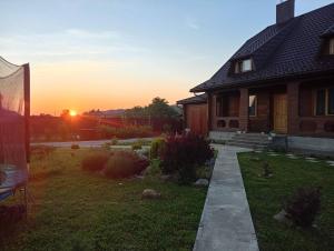 a house with the sunset in the background at Садиба Буквиця in Migovo +13 photos