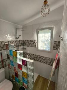 a bathroom with a toilet and a window at Chez Frida in Entre-Deux