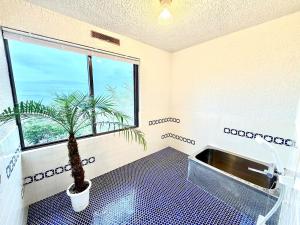 a bathroom with a potted plant and a sink at Harbor Terrace Izu OceanView in Ito