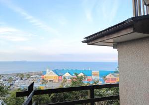 a view of a town from a balcony at Harbor Terrace Izu OceanView in Ito