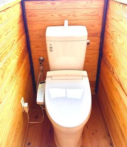 a bathroom with a toilet in a wooden wall at Harbor Terrace Izu OceanView in Ito +14 photos