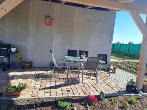 a patio with a table and chairs on it at Ubytování na ranči in Hrabětice +1 photo