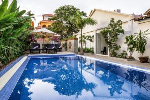 a swimming pool in a villa with a house at Reasey Boutique Villa in Siem Reap