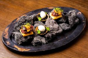 a plate of food with eggs on top of rocks at THE BLESS Awaji in Sumoto