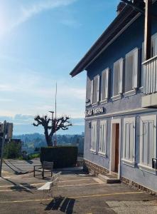 a blue building with a bench in a parking lot at Le BéliMont Panorama in Belmont-sur-Lausanne +17 photos