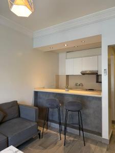 a kitchen with a couch and two bar stools at Ny Suites in Beirut +69 photos