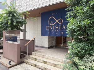 a building with a sign for an entrance to a hotel at ENISIA BASE Kagonma in Kagoshima