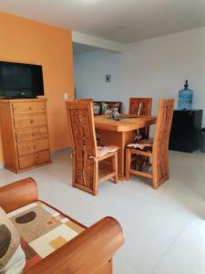 a living room with a wooden table and chairs at Loft los Colibries 6 parking option in Tlaxcala de Xicohténcatl