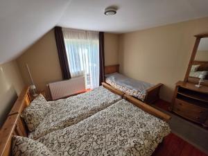a bedroom with two beds and a window at Silentium Clavem Domus III. in Odorheiu Secuiesc +70 photos